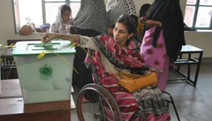 A woman with physical disabilities casting her vote in NA-149 constituency of Multan during 2013 elections in Pakistan. — cbid.org.pk