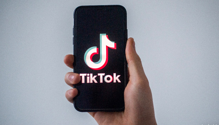 A representational image of a persons holding a smartphone with TikTok seen launched on its screen. — AFP/File