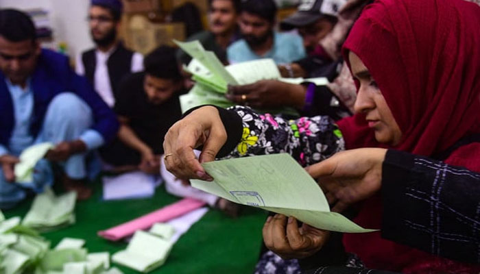 Polling staff start counting votes as polls end during countrys national elections in Karachi on February 8, 2024. — AFP