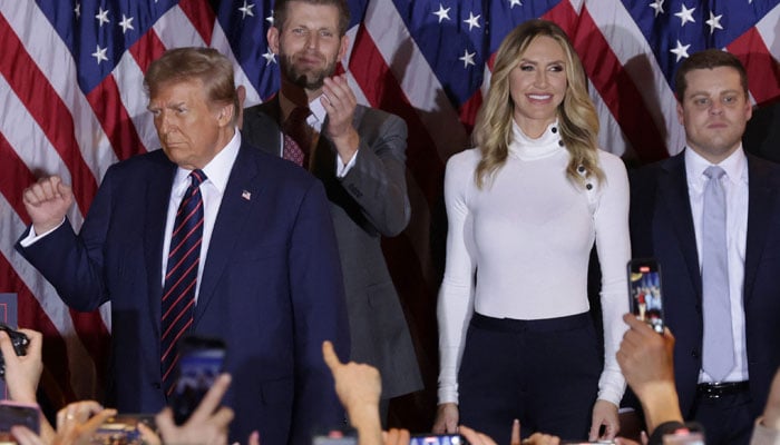 Republican presidential candidate and former U.S. President Donald Trump delivers remarks alongside Eric and Lara Trump during his primary night rally at the Sheraton on January 23, 2024 in Nashua, New Hampshire. — AFP