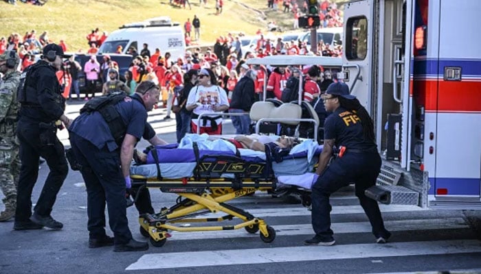 An injured person being loaded on an ambulance by paramedics after shots were fired at the celebration of the Kansas City Chiefs winning Super Bowl LVIII in Kansas City, Missouri, US on February 14, 2024. — AFP