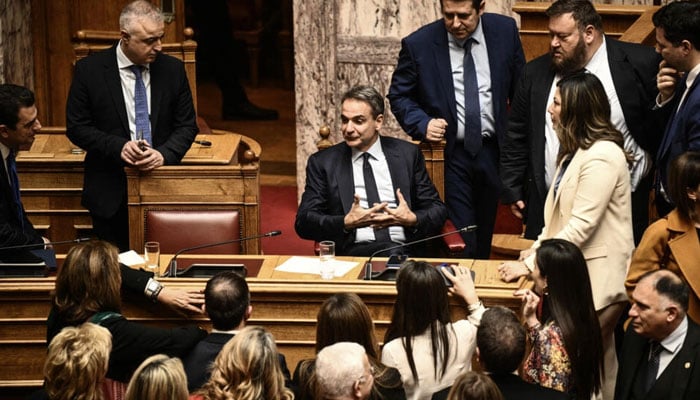 Prime Minister Kyriakos Mitsotakis (C) attends the parliamentary vote on same-sex marriage in Athens, February 15, 2024. — AFP