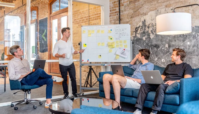 A representational image of a group discussing their business plan. — Unsplash