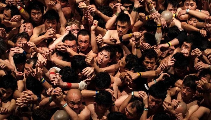 Worshippers wait for the priest to throw sacred batons during the annual Naked Man Festival in western Japan. — AFP/File