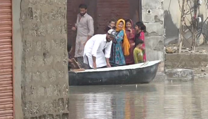 Man using boat to transport goods, residents in flooded streets in Mohalla Band area of Balochistan’s Gwadar. — Reporter