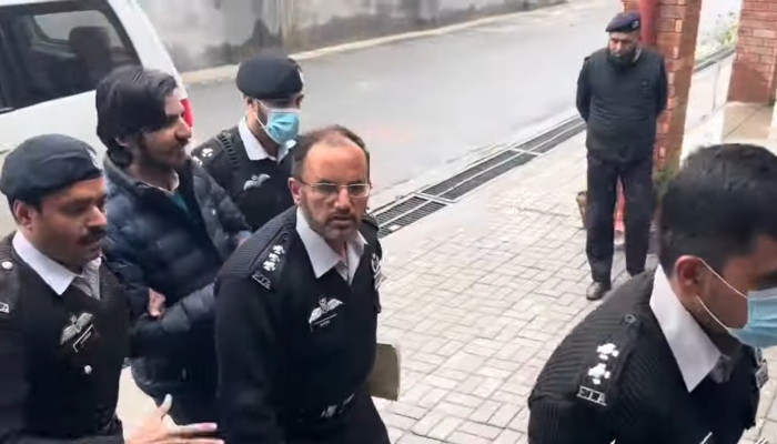Islamabad Police escort YouTuber Asad Toor to a sessions court in Islamabad on March 3, 2024. —YouTube/Matiullah Jan MJtv