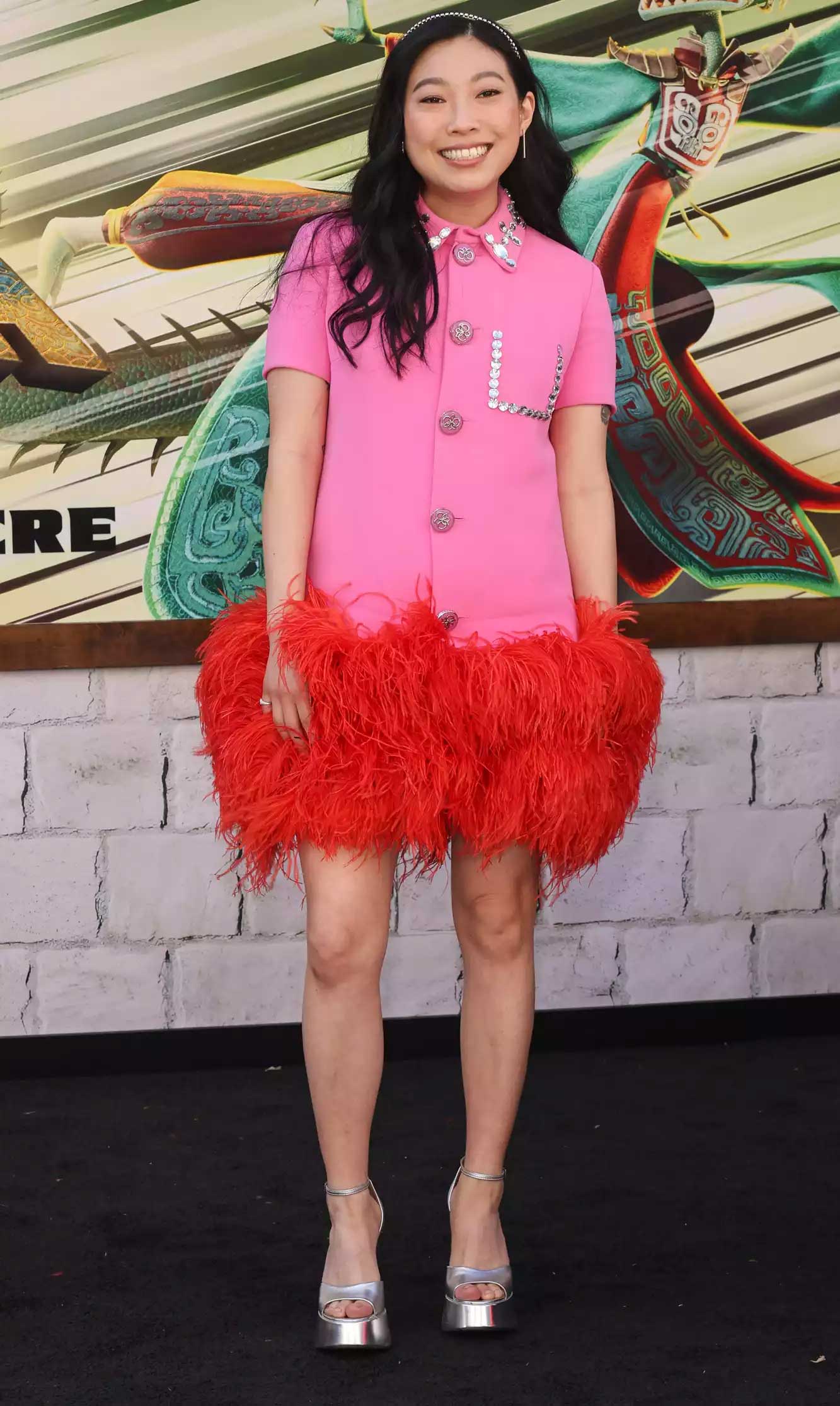 Awkwafina teamed up her bright pink and red dress with silver open toed heels