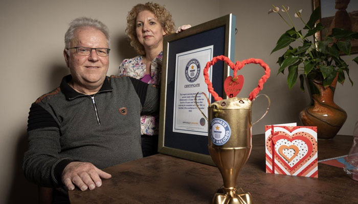 Bert Janssen and his wife Petra, with the framed certificate from the Guinness Book of Records, stating that he is the longest-living patient with a donor heart in the world. — Jeroen Kuit