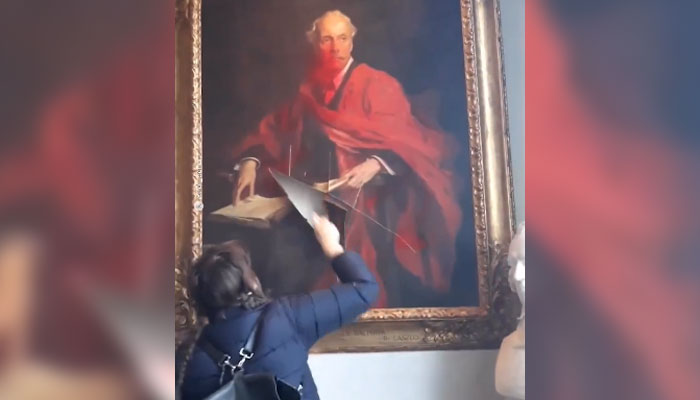 A screengrab of a member of the Palestine Action group slashing the portrait of British politician Arthur Balfour. — Instagram/@redstreamnet