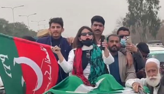 PTIs Seemabia Tahir is seen sitting on top of a vehicle as she leads a protest rally in Rawalpindi on March 10, 2024. — Screengrab/X/@PTIofficial