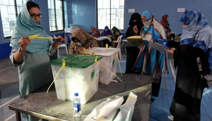 Polling staff open ballot boxes in presence of polling agents from various political parties as they start counting votes at the end of Pakistans national elections in Quetta on February 8, 2024. — AFP