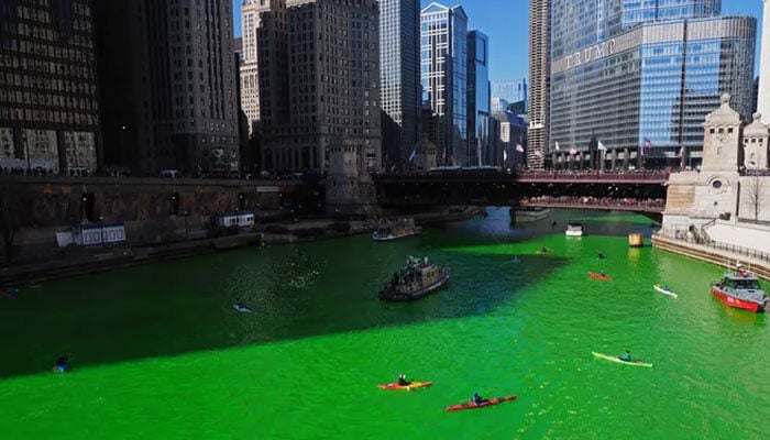 Kayakers paddling in the Chicago river which is dyed green to celebrate St Patrick’s Day. — USA Today/File