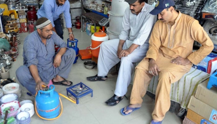 LPG cylinder with a stove is being sold at a shop in Hyderabad on March 17, 2024, as the demand for composite cylinders has increase in the city amid prolonged gas load-shedding. —PPI