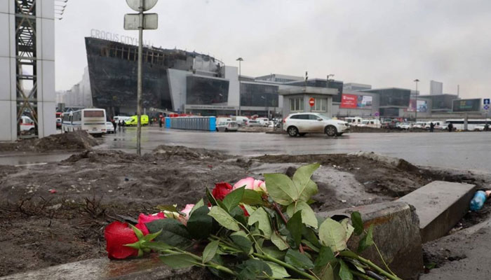 Flowers are seen left at the scene of the gun attack at the Crocus City Hall concert hall in Krasnogorsk, outside Moscow, on March 23, 2024. — AFP