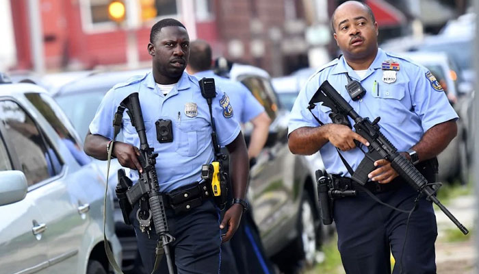 Baby locked inside darkened daycare for a day. — Police officers carrying assault rifles respond to a shooting in Philadelphia, Pennsylvania. - AFP File