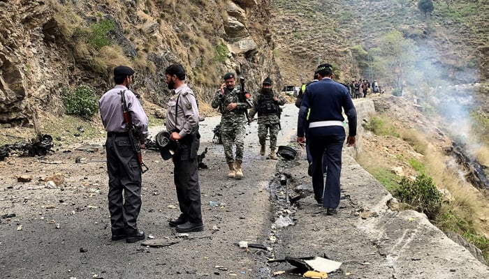 Security personnel inspect the site of the attack near Bisham city in Shangla district of Khyber Pakhtunkhwa province on March 26, 2024. — AFP