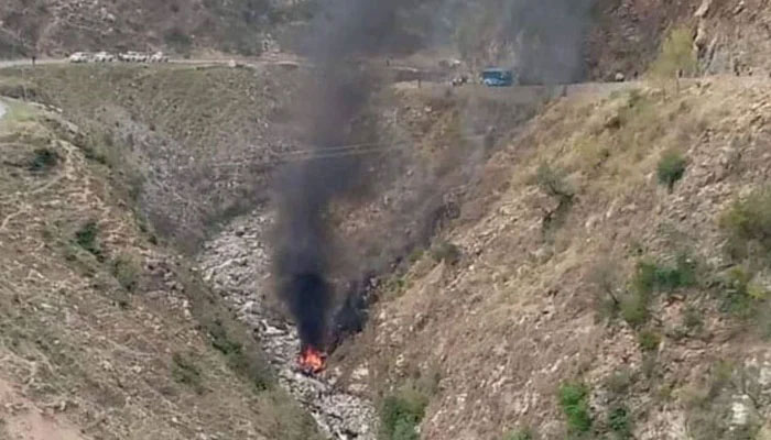 In this still taken from a video, smoke can be seen arising from the wreckage of a burning vehicle in the aftermath of the deadly suicide attack on bus carrying Chinese engineers on March 26, 2024. — X/@AllamaRajaNasir