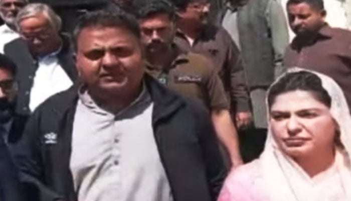 Former minister Fawad Chaudhry (left) is seen with his wife in this still taken from a video. — YouTube/Geo News Live