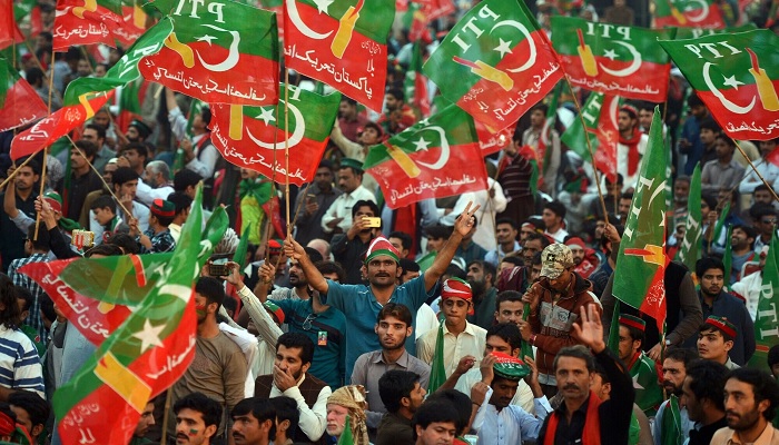 A crowd of PTI supporters wave the partys flag. — AFP/File