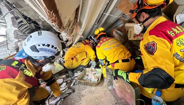 Members of a rescue team search for survivors in a damaged building in Hualien, Taiwan. — APF/File