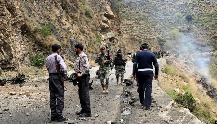 Security personnel inspect the site of a suicide attack in the Shangla district of Khyber Pakhtunkhwa on March 26, 2024. —AFP