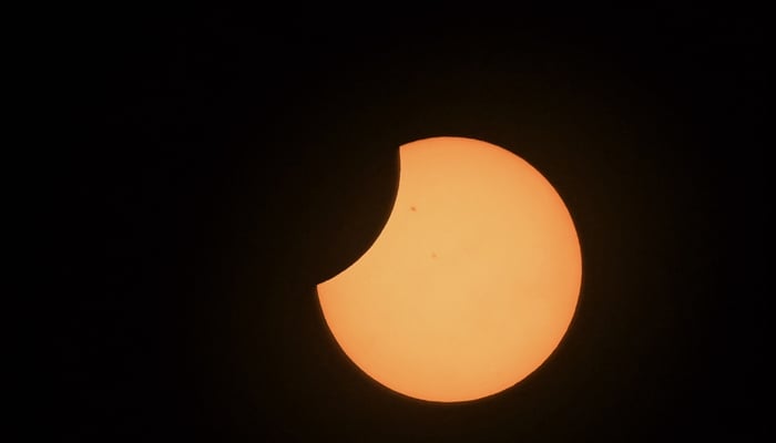 The moon crosses in front of the sun during the annular solar eclipse. — AFP