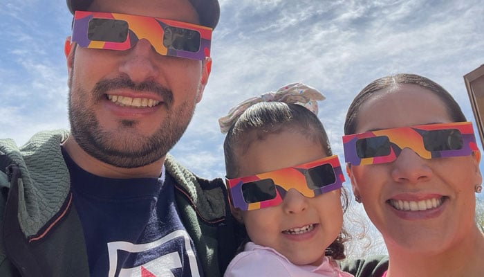 Juan M. Soto Peña, his wife Fabiola and daughter Luciana watch the solar eclipse in Tucson, Arizona. — John M. Soto Locke