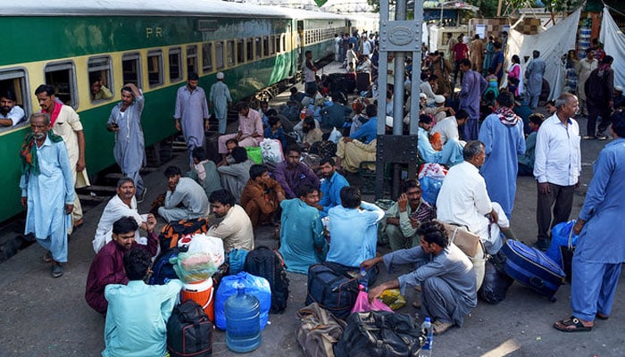 Passengers wait for the train to travel back home to be with their families ahead of the Eid ul Fitr in Karachi on June 2, 2019. — AFP