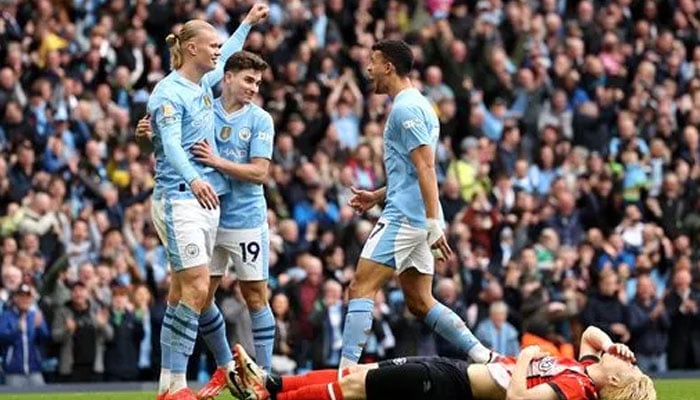 Erling Haalands double secures Manchester Citys win in Premier League match. (Erling Haaland celebrates opening the scoring for Manchester City against Luton on Saturday. — Manchester Evening website)