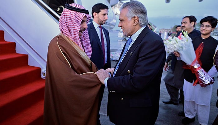 Saudi FM Prince Faisal bin Farhan bin Abdullah (left) shakes hands with FM Ishaq Dar (right) after landing in Islamabad on two-day official visit on April 15, 2024. — X/@ForeignOfficePk