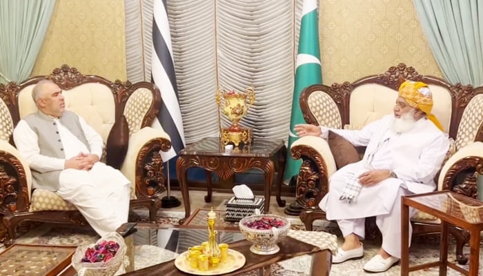PTIs senior leader Asad Qaiser (left) during the meeting with JUI-F chief Maulana Fazlur Rehman in Islamabad, on October 26, 2023, in this still taken from a video. — X/@juipakofficial