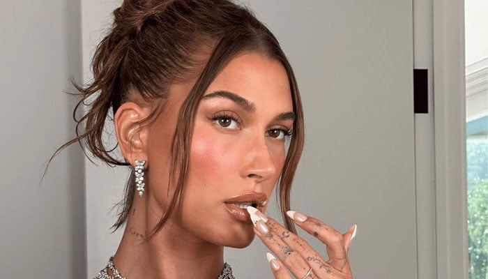 Hailey Bieber takes a closer look at the latest neon manicure