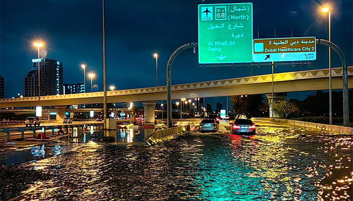 Motorists drive along a flooded street following heavy rains, Dubai, UAE, April 17, 2024. — AFP