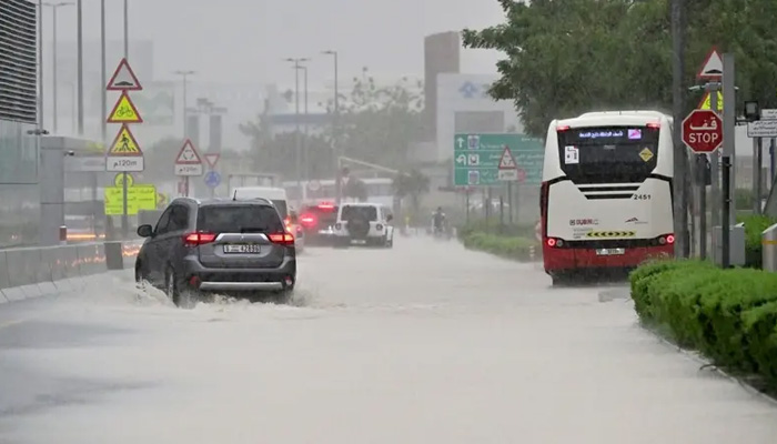 Vehicles drive on a flooded road during torrential rain in the Gulf Emirate of Dubai on April 16, 2024. — AFP