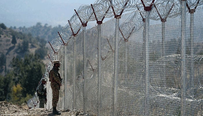 Pakistani soldiers keep vigil next to newly fenced border fencing along with Afghans Paktika province border in Angoor Adda in South Waziristan on Oct 18, 2017. — AFP