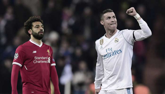 Cristiano Ronaldo and Mohamed Salah gesture during a match. — AFP/File