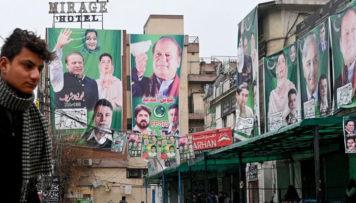 A street is festooned with posters of Pakistan´s former Prime Minister and leader of the Pakistan Muslim League (PML) party, Nawaz Sharif in Lahore on February 4, 2024, ahead of national elections. — AFP