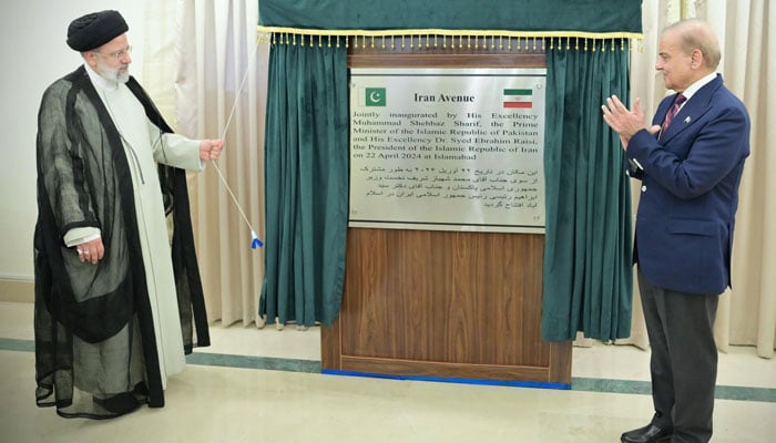 Iranian President Ebrahim Raisi (left) and Prime Minister Shehbaz Sharif unveil the plaque to rename an avenue in the federal capital to Iran Avenue during the formers three-day official visit in Islamabad, April 22, 2024. — X/@PakPMO