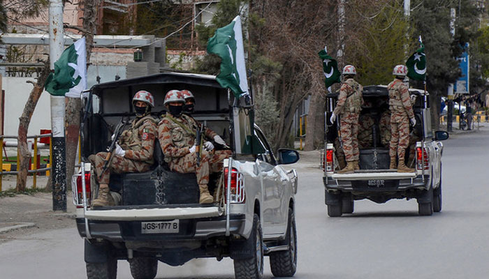 Security personnel patrol with vehicles on a street in Quetta, Pakistan, on March 25, 2020. — AFP/File