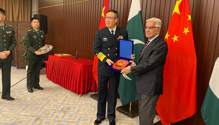 Defence Minister Khawaja Asif (right) meets Chinese counterpart Dong Jun during SCO huddle in Kazakhstan