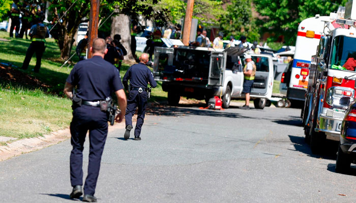 Charlotte Mecklenburg Police Department officers walk in the neighborhood where an officer-involved shooting took place in Charlotte, N.C., April 29, 2024. — ABC website