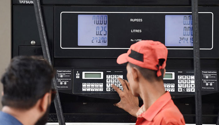 An employee prepares to fill petrol in a vehicle at a fuel station in Karachi on August 1, 2023. — AFP