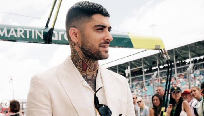 Zayn Malik was photographed at the Aston Martin stand during the race day