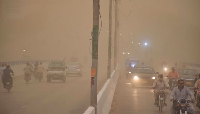 Commuters experience poor visibility as the dust-storm sweeps through Hyderabad on Thursday evening. — INP