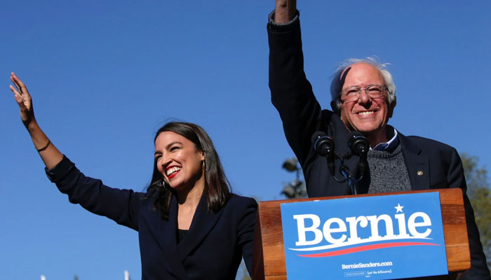 Ocasio-Cortez with Bernie Sanders after she endorsed him at a campaign rally in October 2019 in Queens, New York. — AFP File