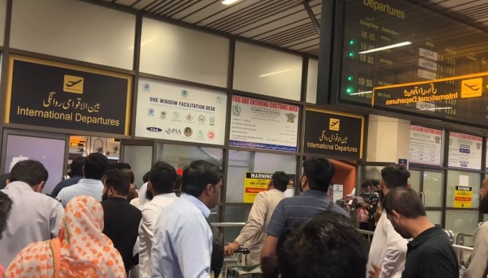 People are queued at the International Departures counter at the Allama Iqbal International Airport, Lahore, in the still taken from a video uploaded on June 14, 2023. —YouTube/ Mansoortastic
