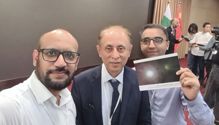 iCube-Qamar core team comprising Dr Rehan Mahmood (right), Dr Qamarul Islam(center) and Dr Khurram Khurshid (left), carrying the image sent via the satellite on Friday May 10, 2024. — IST