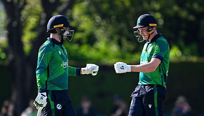 Irish batsmen bumb fists during second innings of opening match of ongoing T20I series in Dublin on May 10, 2024. — PCB