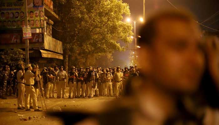 Police personnel stand guard after clashes broke out during a Hindu religious procession in Jahangirpuri area of New Delhi, India, April 16, 2022. — Reuters