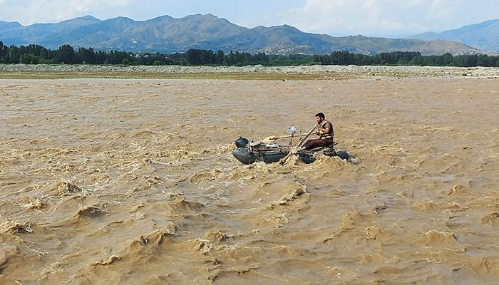 A rescue worker rows a raft while searching for survivors, after tourists, who were on a picnic, were swept away by overflowing floodwaters in the Swat River, in Swat Valley on June 27, 2025. — Reuters